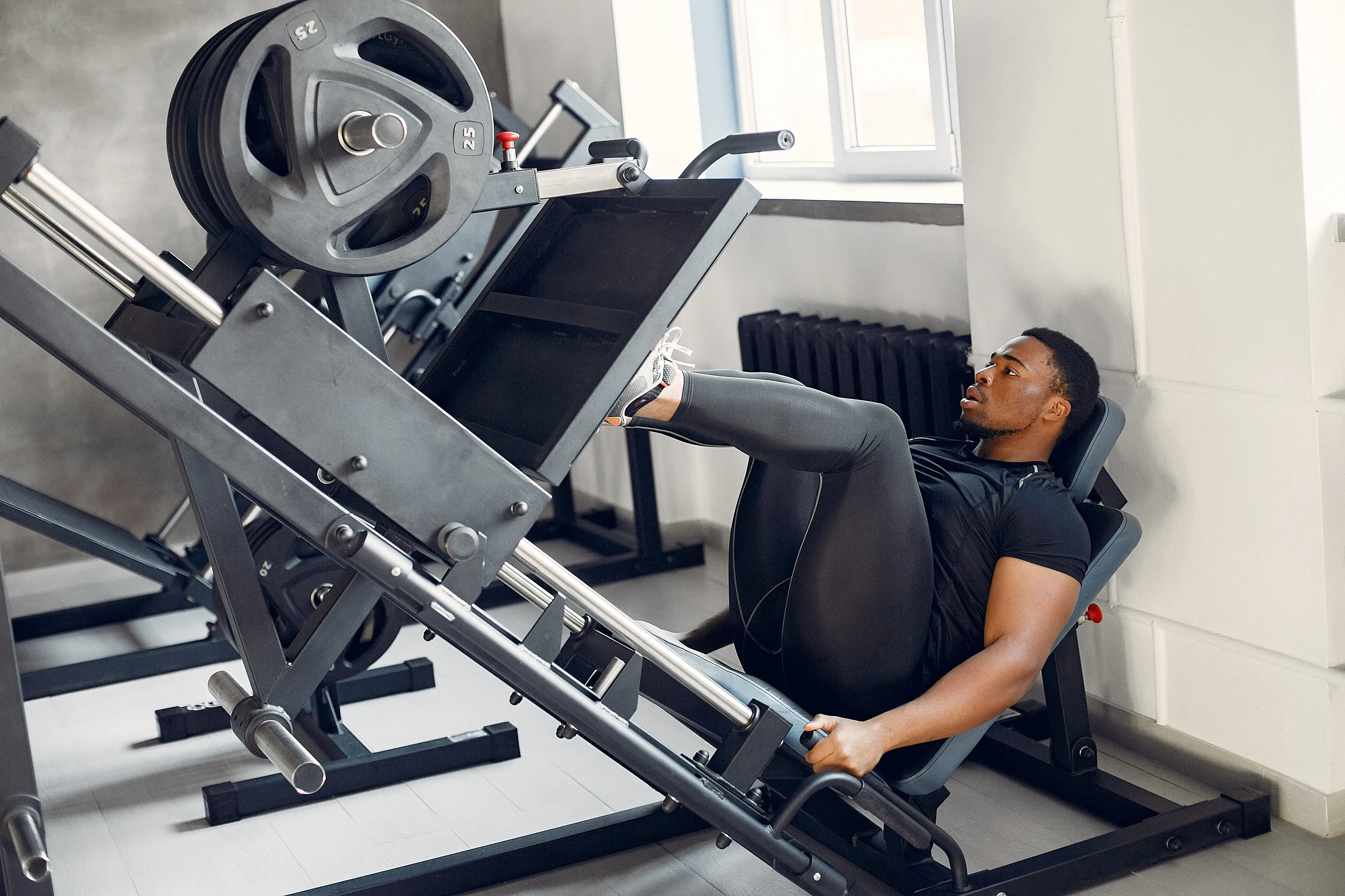 Gym professional working on equipment